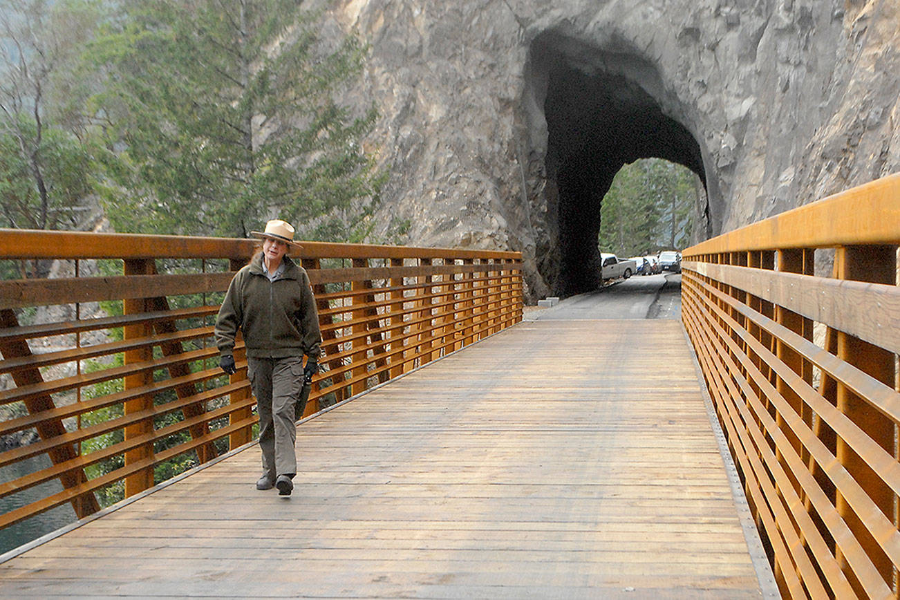 Olympic National Park Superintendent Sarah Creachbaum walks across a new bridge on the Spruce Railroad Trail abutting the recently renovated Daley-Rankin Tunnel at the start of a ceremony on Oct. 29 to celebrate the soon-to-be-open trail on the north shore of Lake Crescent. Photo by Keith Thorpe/Olympic Peninsula News Group
