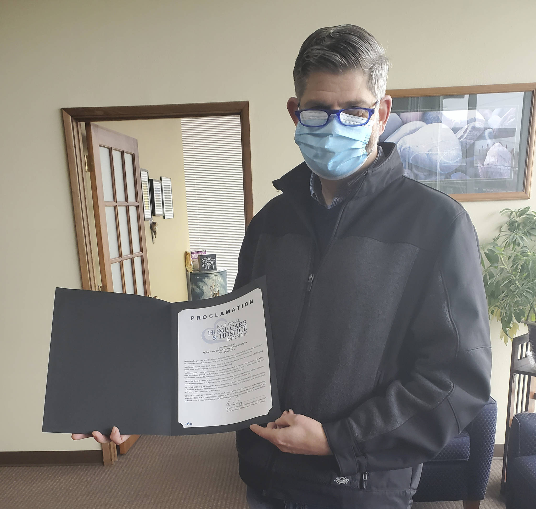 Clallam County commissioner Mark Ozias signs a proclamation for National Home Care & Hospice Month on nov. 2 at Assured Hospice of Clallam and Jefferson Counties in Port Angeles. Submitted photo