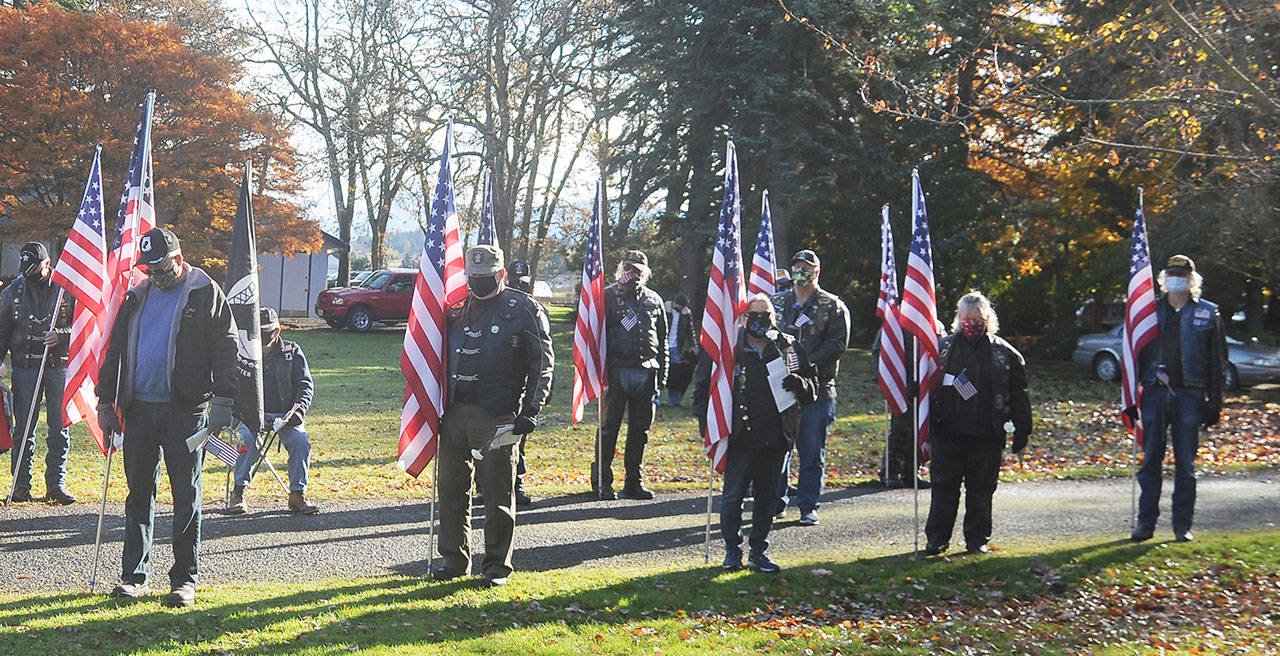 Members of the American Legion riders reflect as Jack Grennan Post 62 chaplain Nancy Zimmerman offers a prayer at the Nov. 11 Veterans Day ceremony on Nov. 11. Sequim Gazette photo by Michael Dashiell