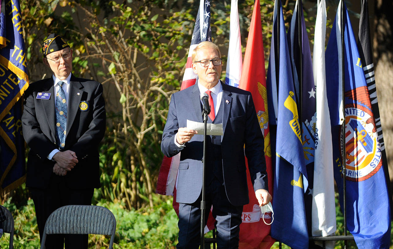 Sequim mayor William Armacost, right, addresses the crowd the the Nov. 11 Veterans Day event at Pioneer Memorial park, as emcee Paul Renick, commander of Jack Grennan Post 62 American Legion, listens. Sequim Gazette photo by Michael Dashiell