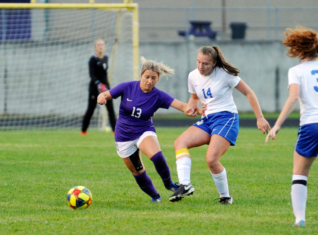 Sequim midfielder Natalya James, left, vies for the ball during a 2019 win over Bremerton. James recently signed to play soccer at Edmonds College. Sequim Gazette file photo by Michael Dashiell