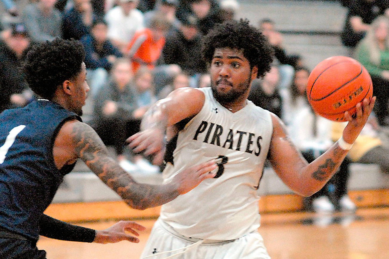 Peninsula's Davien Harris-Williams prepares to pass as Bellevue's Tijohn Rodde defends the lane in a February NWAC match-up. Peninsula College student-athletes gained an eligibility waiver for this season because of the effects of the COIVD-19 pandemic on NWAC sports seasons. File photo by Keith Thorpe/Olympic Peninsula News Group
