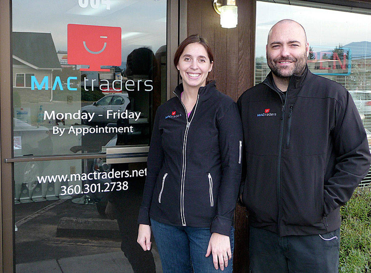 Kecia and Glenn Gilliam stand outside their business MacTraders soon after its opening in late 2014. The Gilliams are selling the business that markets and offers services for used and refurbished Apple products. Sequim Gazette file photo by Patricia Morrison Coate