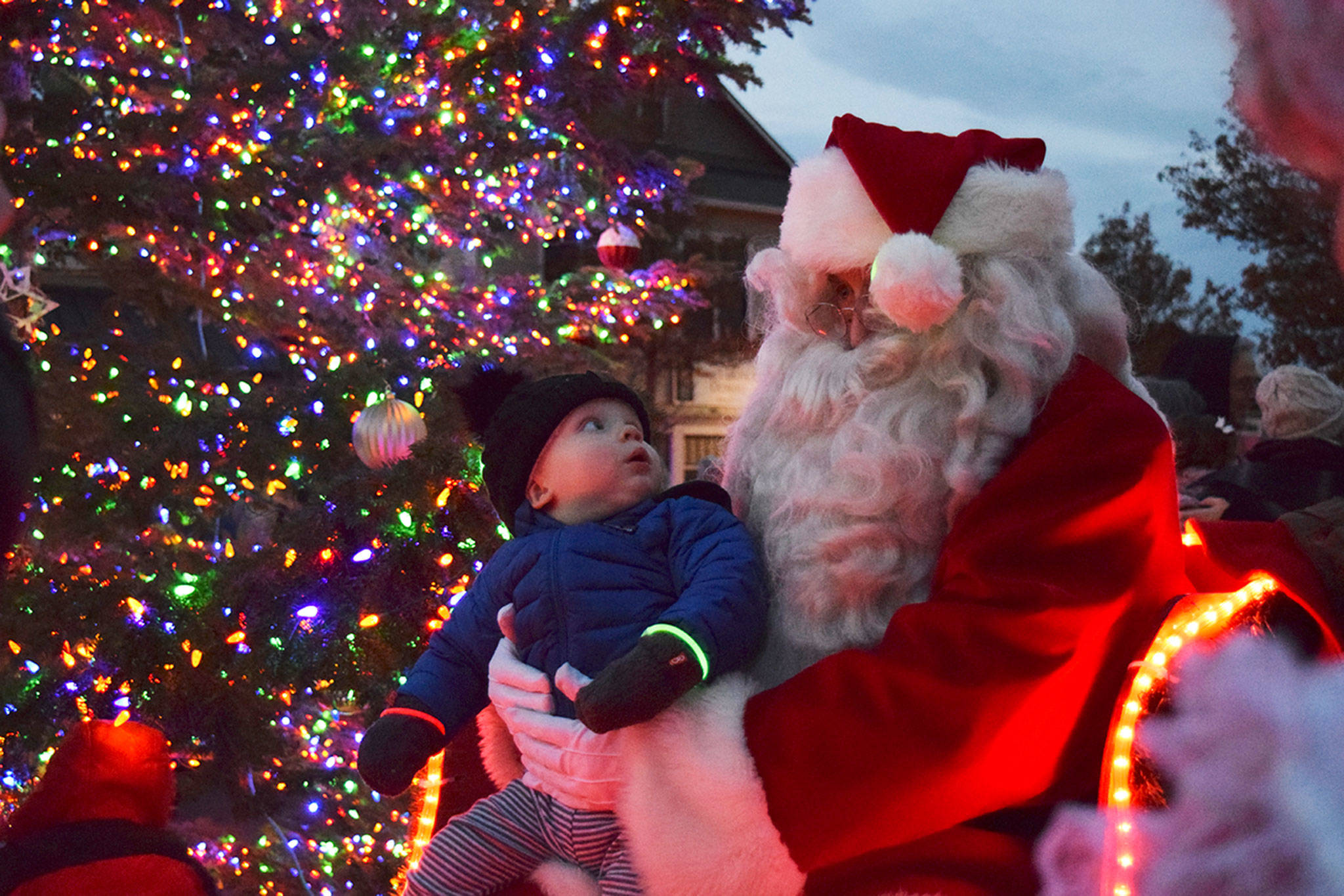 Magic moments like this between Dylan Krashan and Santa Claus in 2018 won’t happen this year at the downtown Sequim tree lighting event due to pandemic protocols coming into place. The tree lighting moves online to 5 p.m. on Thanksgiving at the Sequim-Dungeness Valley Chamber of Commerce’s website and social media pages. Sequim Gazette file photo by Erin Hawkins