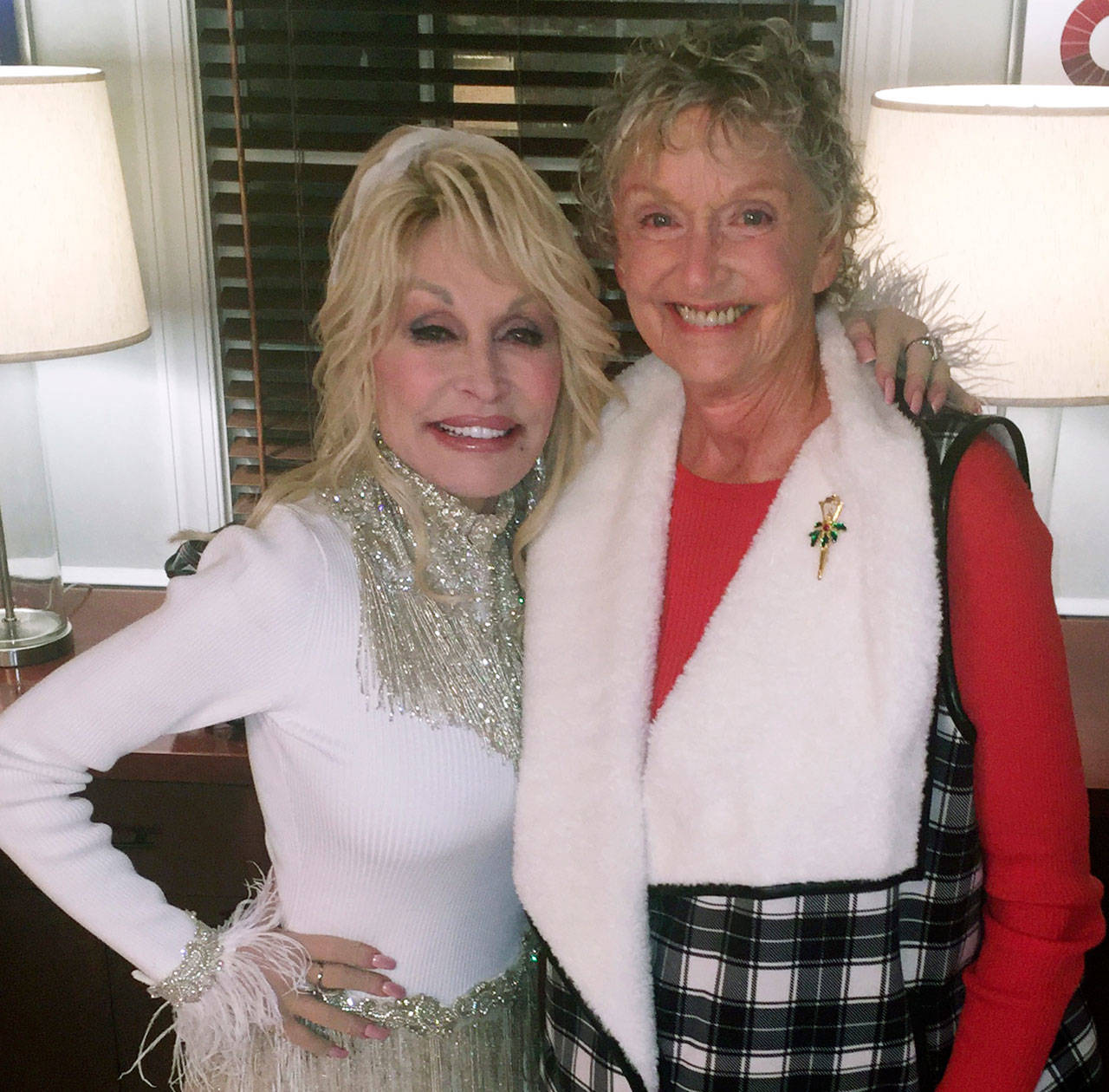 Singing and acting legend Dolly Parton shares a moment with fellow cast member Carol Swarbrick Dries on the set of “Christmas on the Square.” Filmed in the summer of 2019, the show made its debut Nov. 22, 2020, on Netflix. Photo courtesy of Carol Swarbrick Dries