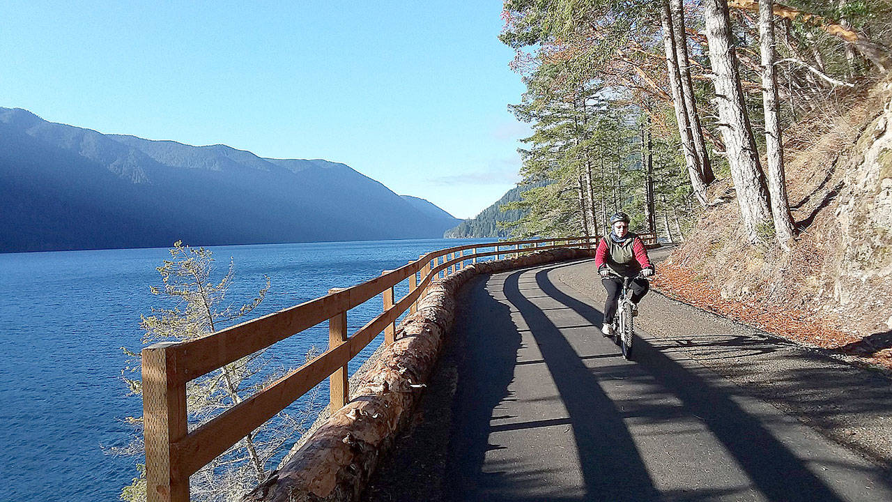 Bicyclists and hikers enjoy beautiful weather at the new Spruce Railroad Trail on Dec. 2 on the north shore of Crescent Lake. Here a cyclist rides the trail just west of the Daley Rankin Tunnel. Photo by Pierre LaBossiere/Olympic Peninsula News Group