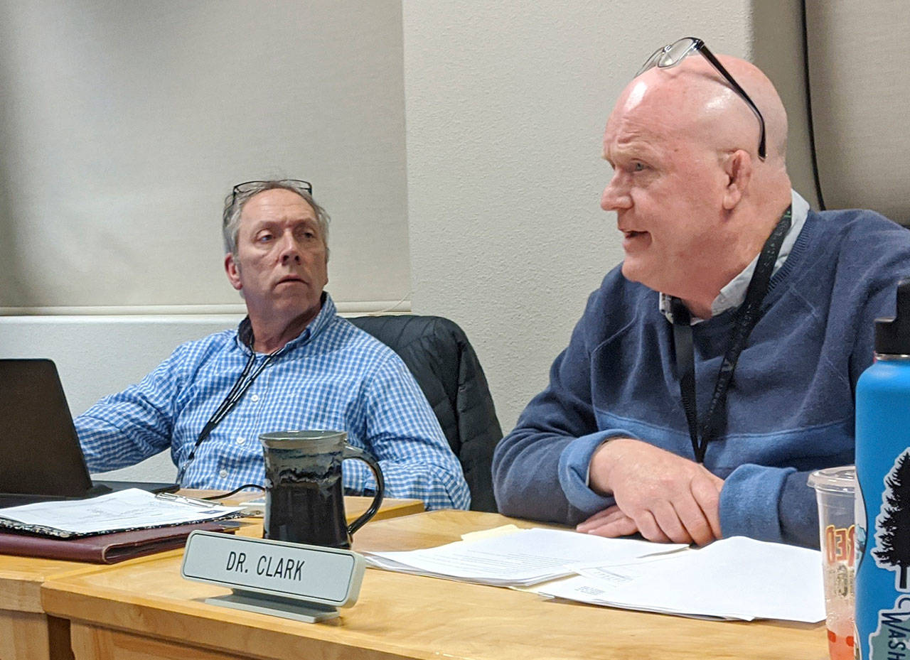 Sequim School District superintendent Rob Clark, right, discusses terms of his contract extension with the school board while board president Brandino Gibson listens on during a school board meeting in January 2020. Clark was placed on leave as of Oct. 22 pending the outcome of a complaint, and on Jan. 14 Sequim School District officials announced he’s resigning his top administrator position. Sequim Gazette file photo by Conor Dowley