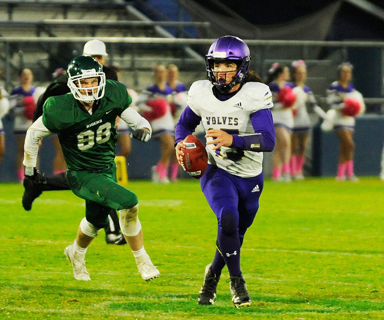 Sequim quarterback Taig Wiker evades the rush from Port Angeles defenders in an Olympic league match-up in October 2019. Prep football could begin as soon as Feb. 1. Olympic League officials are in conversations with other high schools to form leagues for shortened seasons. Sequim Gazette file photo by Michael Dashiell
