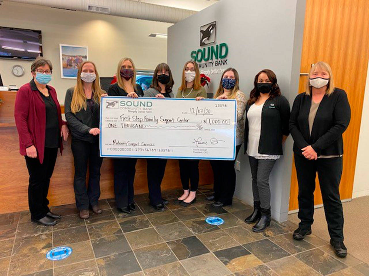 Staff at Sound Community Bank joins Kathy Murphy-Carey, First Step Family Support Center’s board president, far left, and First Step executive director Nita Lynn, far right, for the recent presentation of a $1,000 donation that will help support the nonprofit’s Maternity Support Services Program. Submitted photo