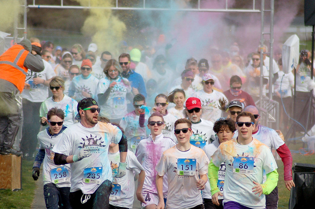 Runners participating in the 5k race sprint out at the start of the Sequim Sunshine Festival Sun Fun Color Run at the Albert Haller playfields in March 2020. Registration for the 2021 event is open now, with options for alive race on march 6 and “virtual” race March 6-31. Sequim Gazette file photo by Conor Dowley