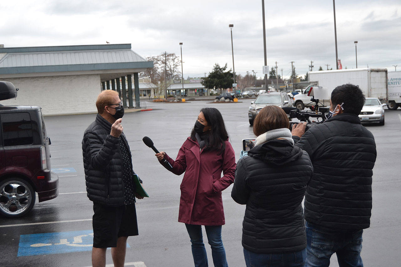 CNN’s senior national correspondent Kyung Lah interviews Sequim mayor William Armacost after a Coffee with the Mayor session on Jan. 28 about QAnon as producer Kim Berryman and photojournalist Taka Yokoyama and record the conversation that appeared on a segment of “Anderson Cooper 360” the next night. Armacost said he never publicly supported QAnon. Sequim Gazette photo by Matthew Nash