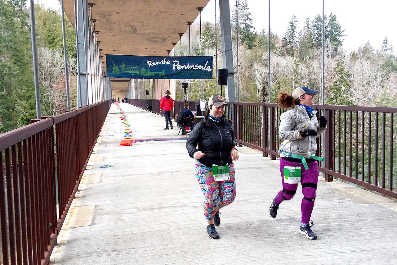 Brady Simis of Renton, left and Angela Smith of Buckley get started on their 10K runs at the Elwha Bridge Run Saturday morning. Photo by Pierre LaBossiere/Olympic Peninsula News Group