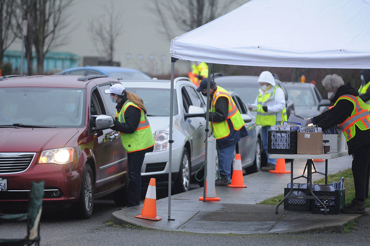Volunteers help check in patients and provide information at the Jamestown Family Health Clinic vaccination event on Feb. 4 at Trinity United Methodist Church and Carrie Blake Community Park. Sequim Gazette photo by Michael Dashiell