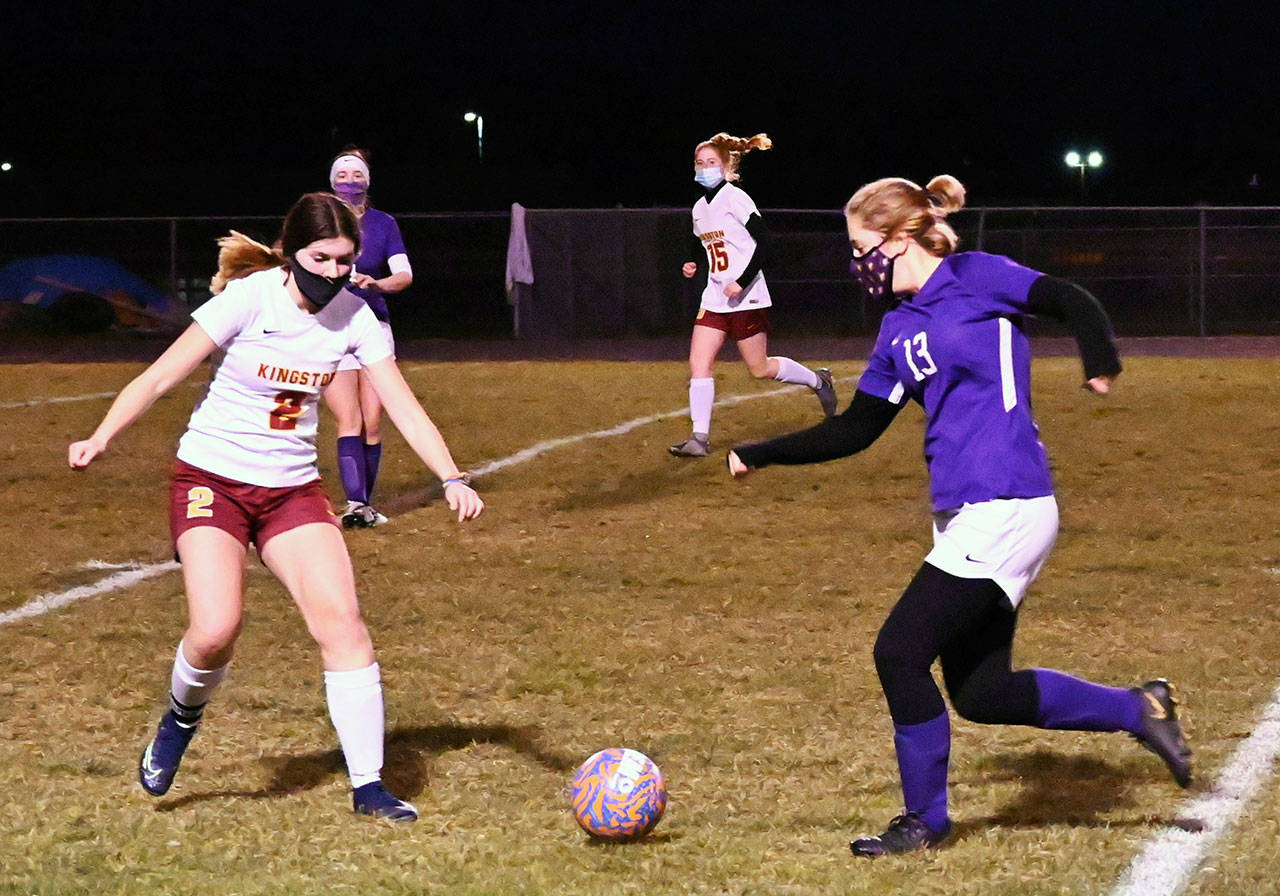 Sequim’s Payton Johnson, right, looks to advance the ball into Kingston territory past midfielder Mandy Dormaier in the Wolves’ 2-1 win over the Buccaneers on Feb. 18. Sequim Gazette photo by Michel Dashiell