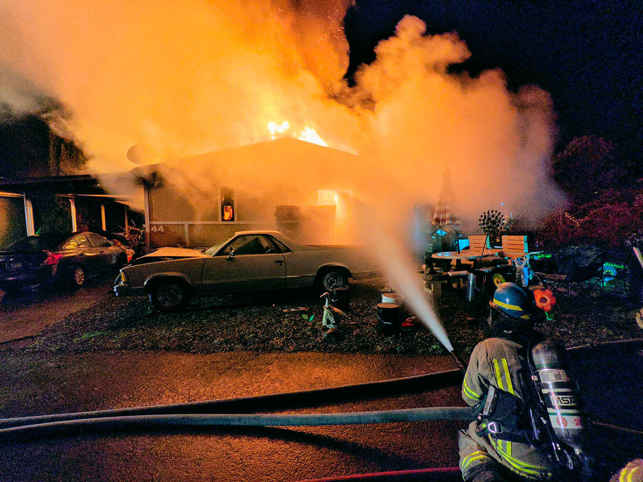 Clallam County Fire District 3 personnel battle a mobile home fire on the 900 block of South Third Avenue on Feb. 23. A resident who was able to get out of the home died a day later, according to relatives. Photo by Fire District 3/Facebook page