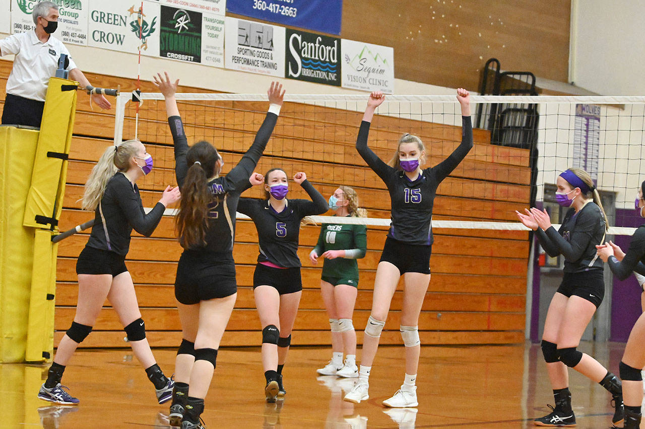 Sequim players celebrate a set victory as they take on Port Angeles at home on Feb. 25. Sequim edged the Roughriders in four sets. Sequim Gazette photo by Michael Dashiell