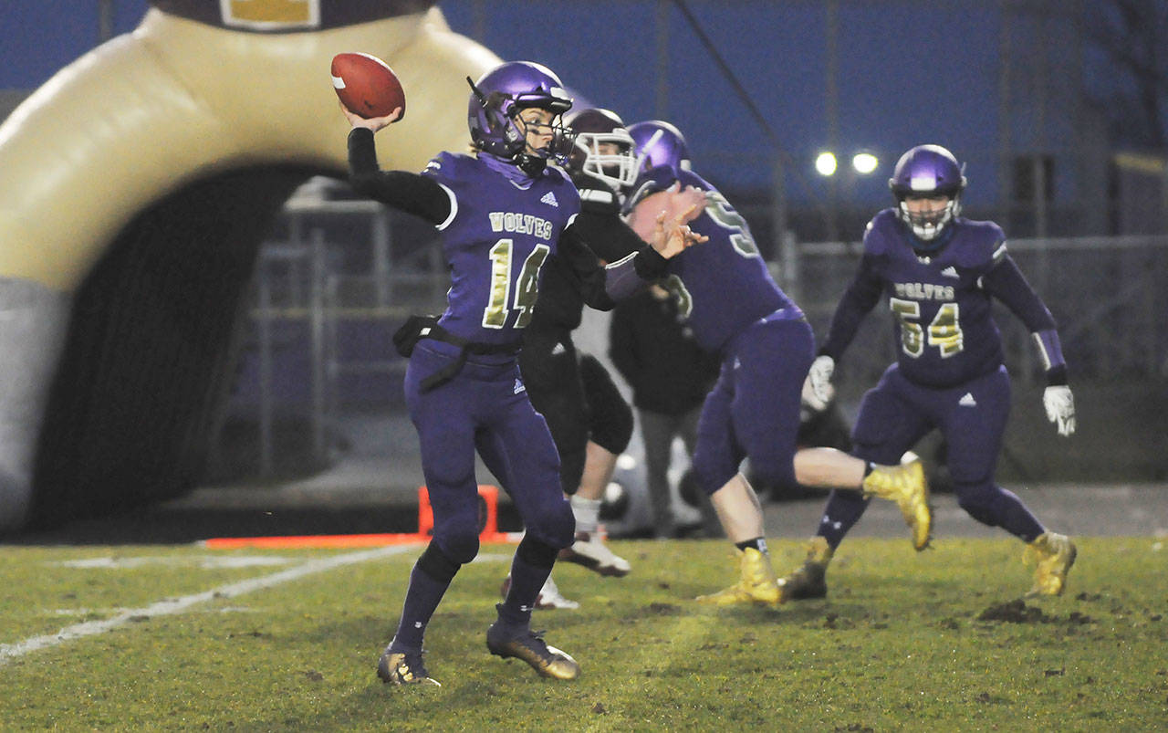 Sequim quarterback Kobe Applegate looks for a receiver in the first half of the Wolves’ 27-15 win over South Kitsap on March 5. Sequim Gazette photo by Michael Dashiell