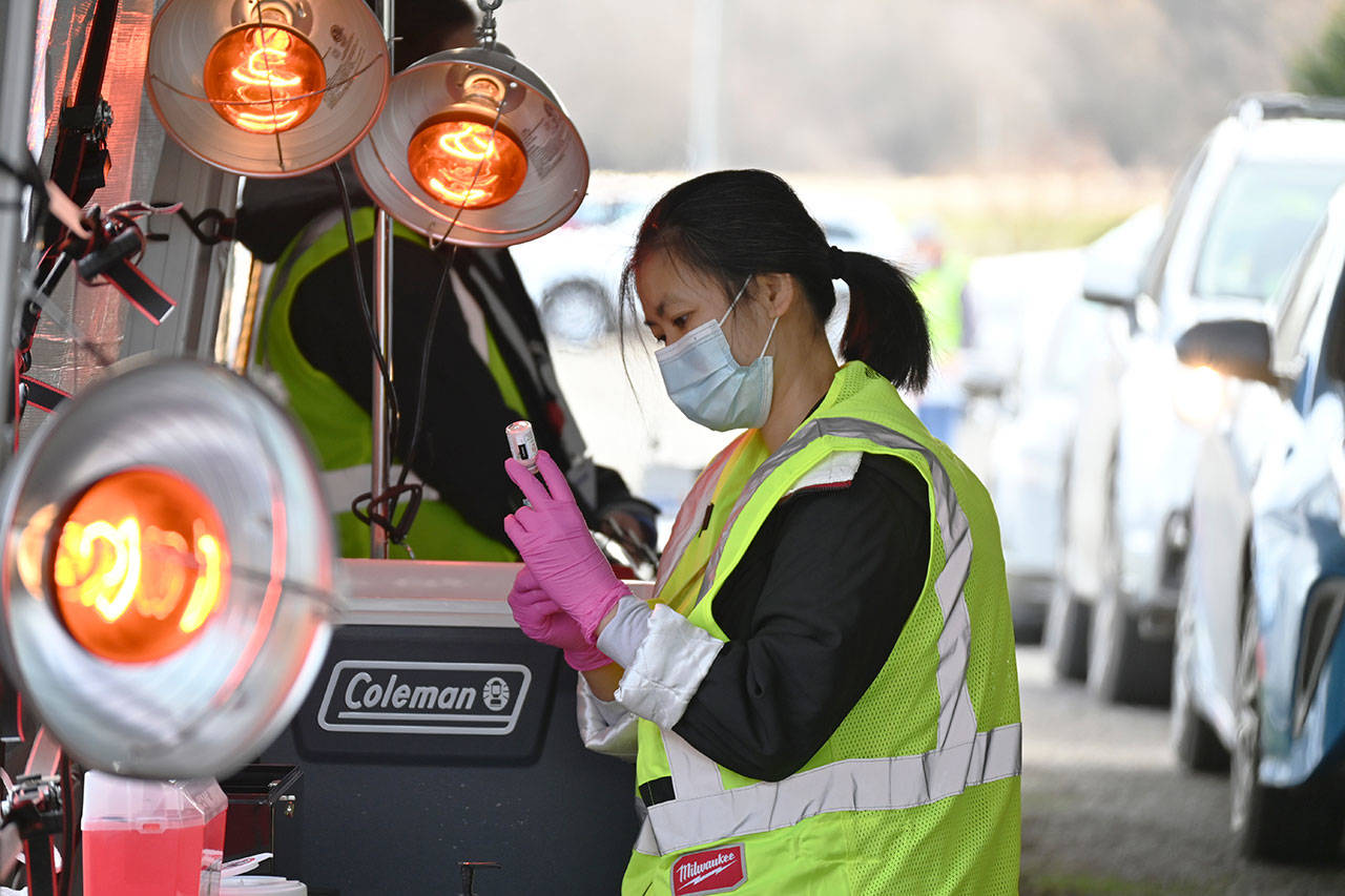 Certified medical assistant Lu Thu Hardin prepares a COVID-19 vaccination dose at the Jamestown Family Health Clinic drive-thru clinic in Sequim on March 4. Sequim Gazette photo by Michael Dashiell
