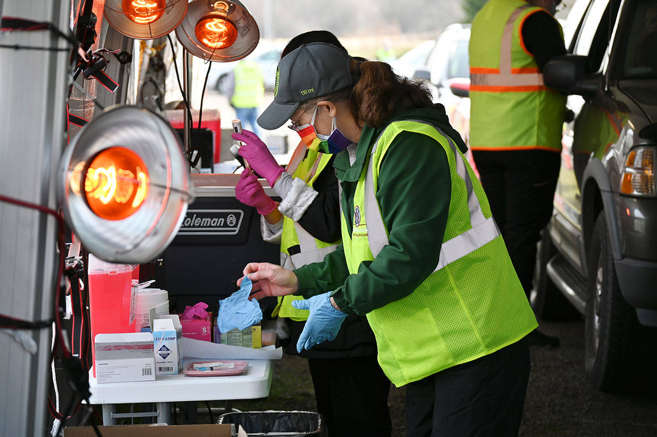 Volunteer nurse Michelle Grinnell preps COVID-19 vaccination doses at the Jamestown Family Health Clinic drive-thru clinic in Sequim on March 4. Sequim Gazette photo by Michael Dashiell