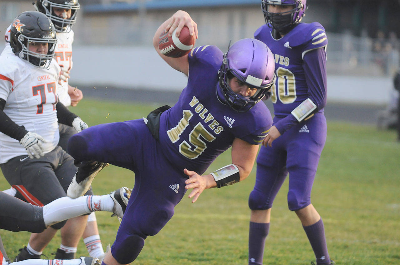 Sequim quarterback Taig Wiker dives in for a 6-yard touchdown in the first half of the Wolves’ 38-22 win over Central Kitsap on March 18. Wiker rushed for 130 yards and two scores, and threw for another 166 yards and a touchdown. Sequim Gazette photo by Michael Dashiell