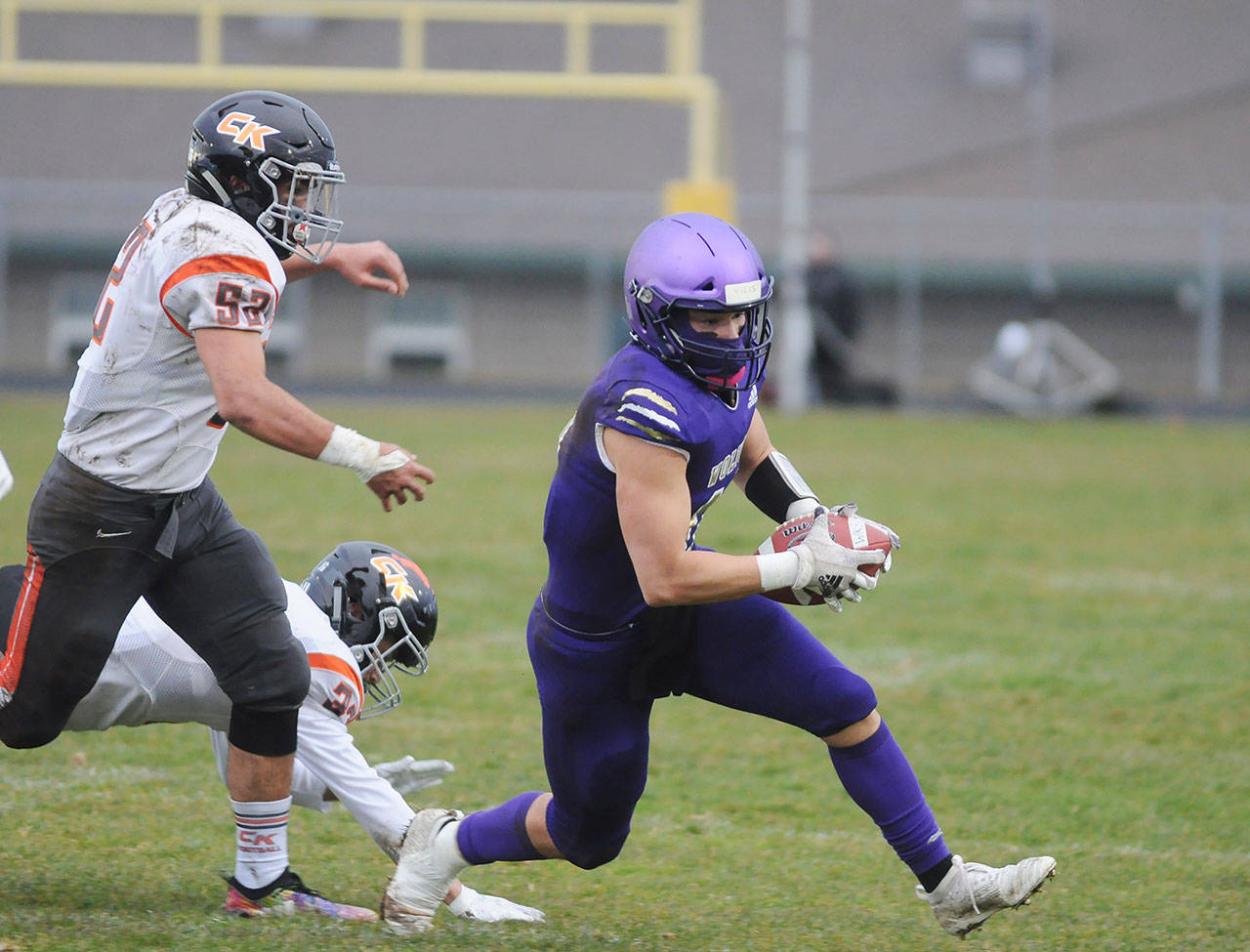 Sequim receiver Michael Young takes a sweep and eyes yardage in the first half of the Wolves’ March 18 win over visiting Central Kitsap. Young had two key interceptions — one for a touchdown — in the win. Sequim Gazette photo by Michael Dashiell