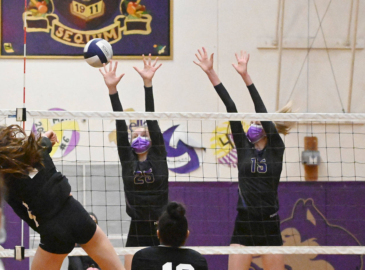 Sequim’s Jolene Vaara (25) and Kendall Hastings look to put a block on Central Kitsap’s Camryn Lingenbrink in an Olympic League crossover match on March 20 in Sequim.