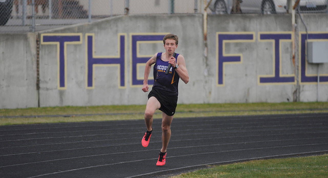 Sequim freshman Colby Ellefson anchors the Wolves’ 4x400 relay team as they host Olympic on March 24. Sequim Gazette photo by Michael Dashiell