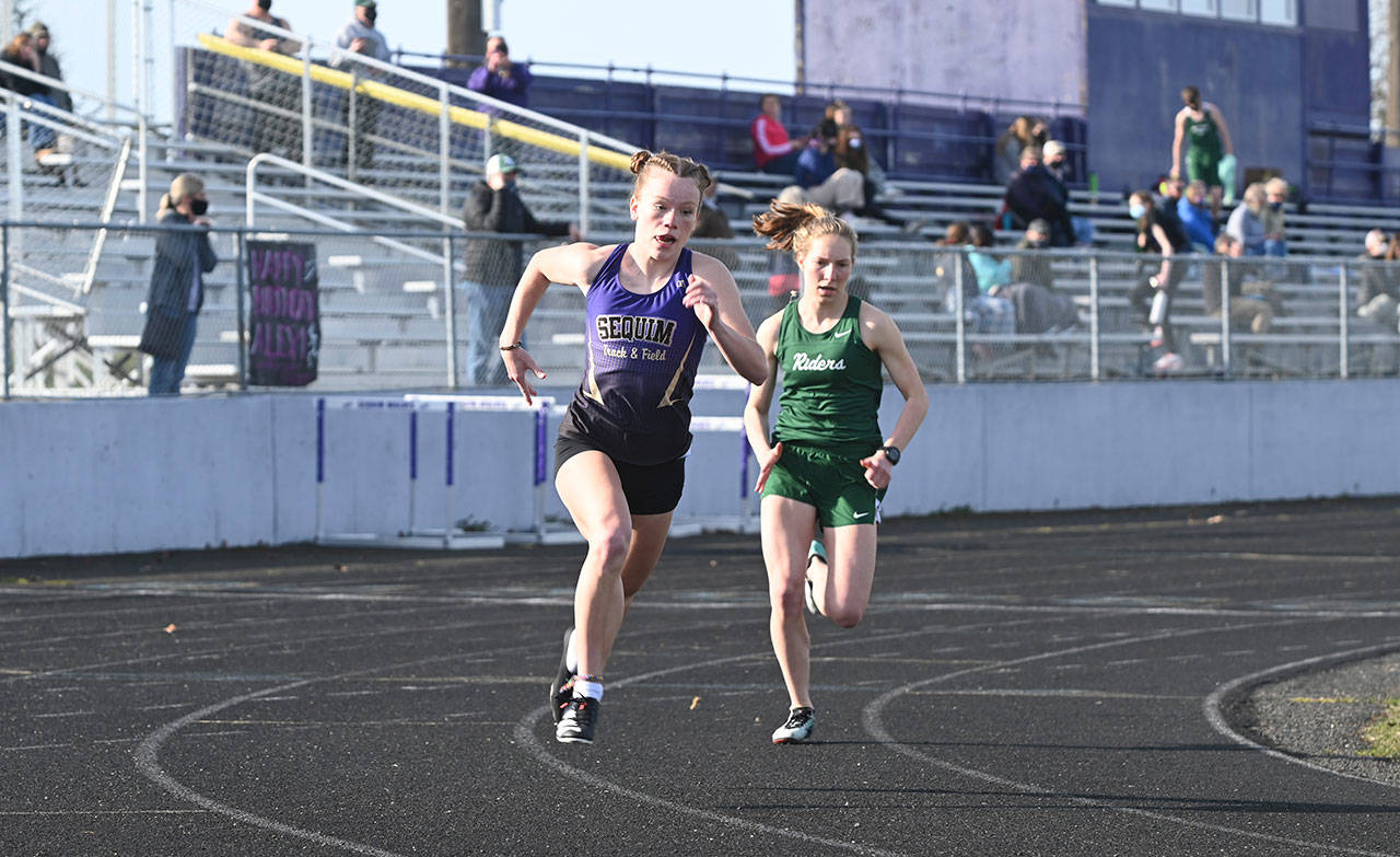 Sequim’s Riley Pyeatt, left, and Port Angeles’ Lauren Larson square off in the 800 meters at a league track and field meet in Sequim on March 31. Larson won the event in 2:18, with Pyeatt second in 2:31. Sequim Gazette photo by Michael Dashiell