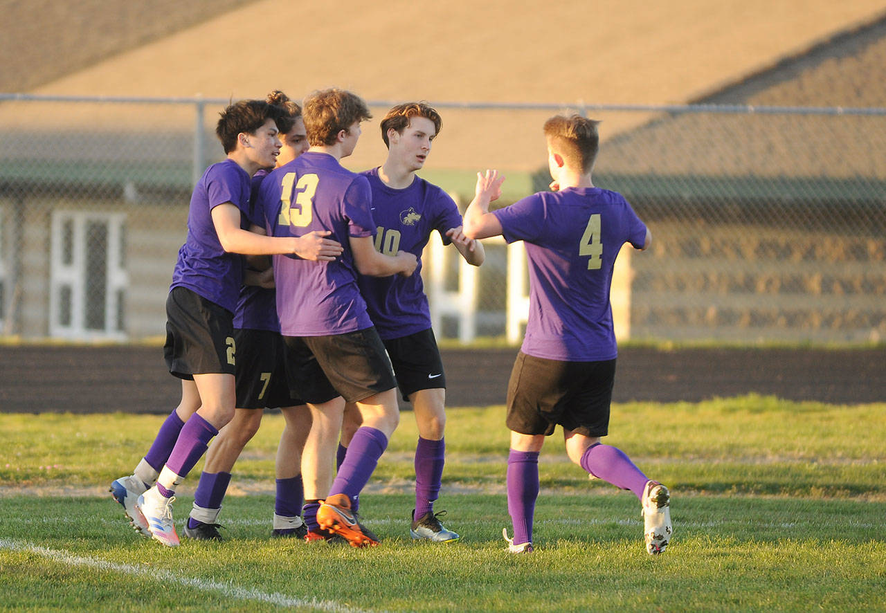 Teammates surround SHS senior Eli Gish, center, after his score in the first half of a 2-0 win over Port Angeles on March 25. Gish was named WIAA/Gesa Credit Union State Athlete of the Week for March 21-27. Sequim Gazette file photo by Michael Dashiell