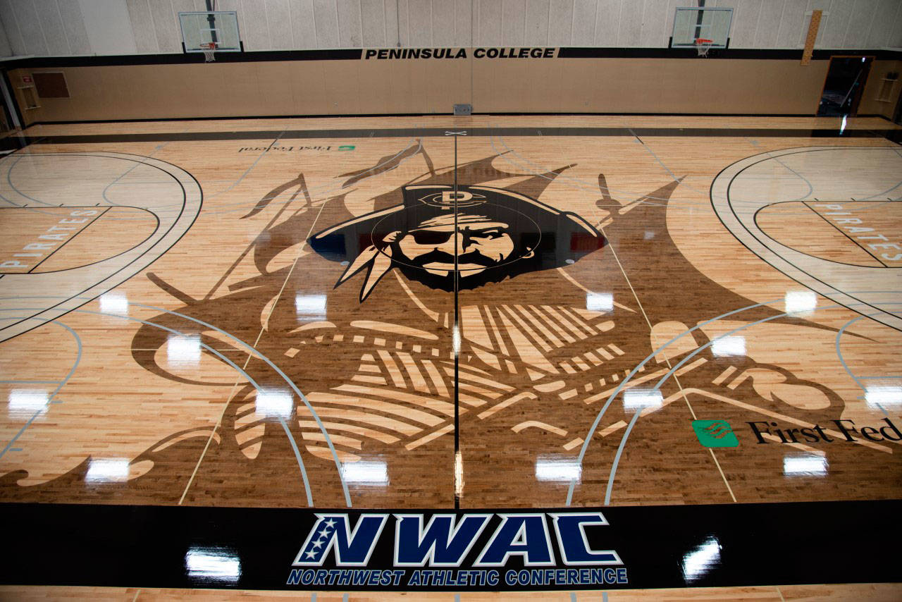 A community-led fundraising drive garnered $200,000 to replace the gym floor at Peninsula College. PC players, fans and representatives will dedicate the floor this Saturday, April 3, at halftime of the men’s game against visiting Everett. Photo courtesy of Peninsula College