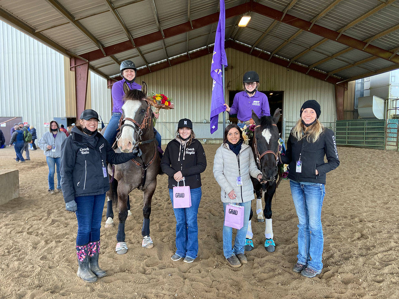Sequim Equestrian Team seniors (back, left) Abby Garcia, on Burd, and Keri Tucker, on Nikki, take a break from the action at the second district meet in early April in Elma. Honoring the seniors are, from left, coach Katie Salmon-Newton and coaches Haylie Newton, Miranda Williams and Bettina Hoesel. Submitted photo
