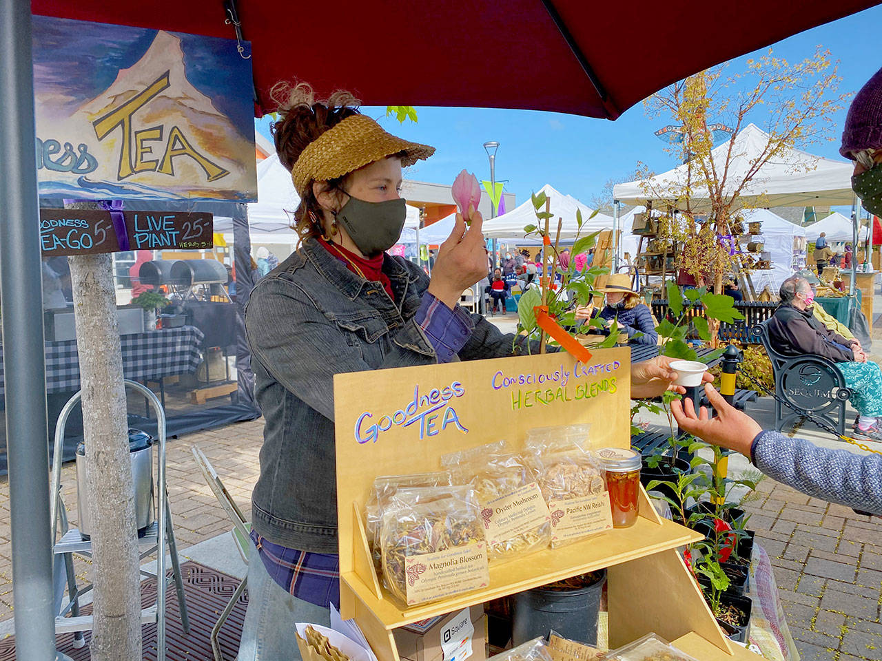 Shaelee Evans helps a customer at the Goodness Tea booth on May 1, the opening day of the market’s 2021 season. Photo by Emma Jane Garcia/Sequim Farmers & Artisans Market