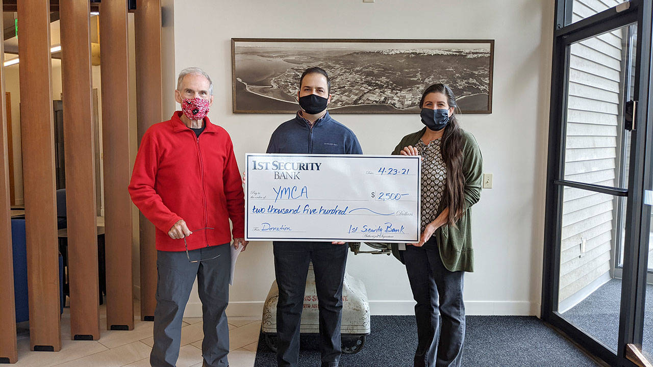 At left, Gary Huff, board director and campaign chairman for the Olympic Peninsula YMCA’s 2021 Impact Campaign, accepts a donation for the YMCA from 1st Security Bank, represented here by VP Branch Manager Anthony Aceto and 1st Security personal banker Sheena Zahn. Photo courtesy of Olympic Peninsula YMCA