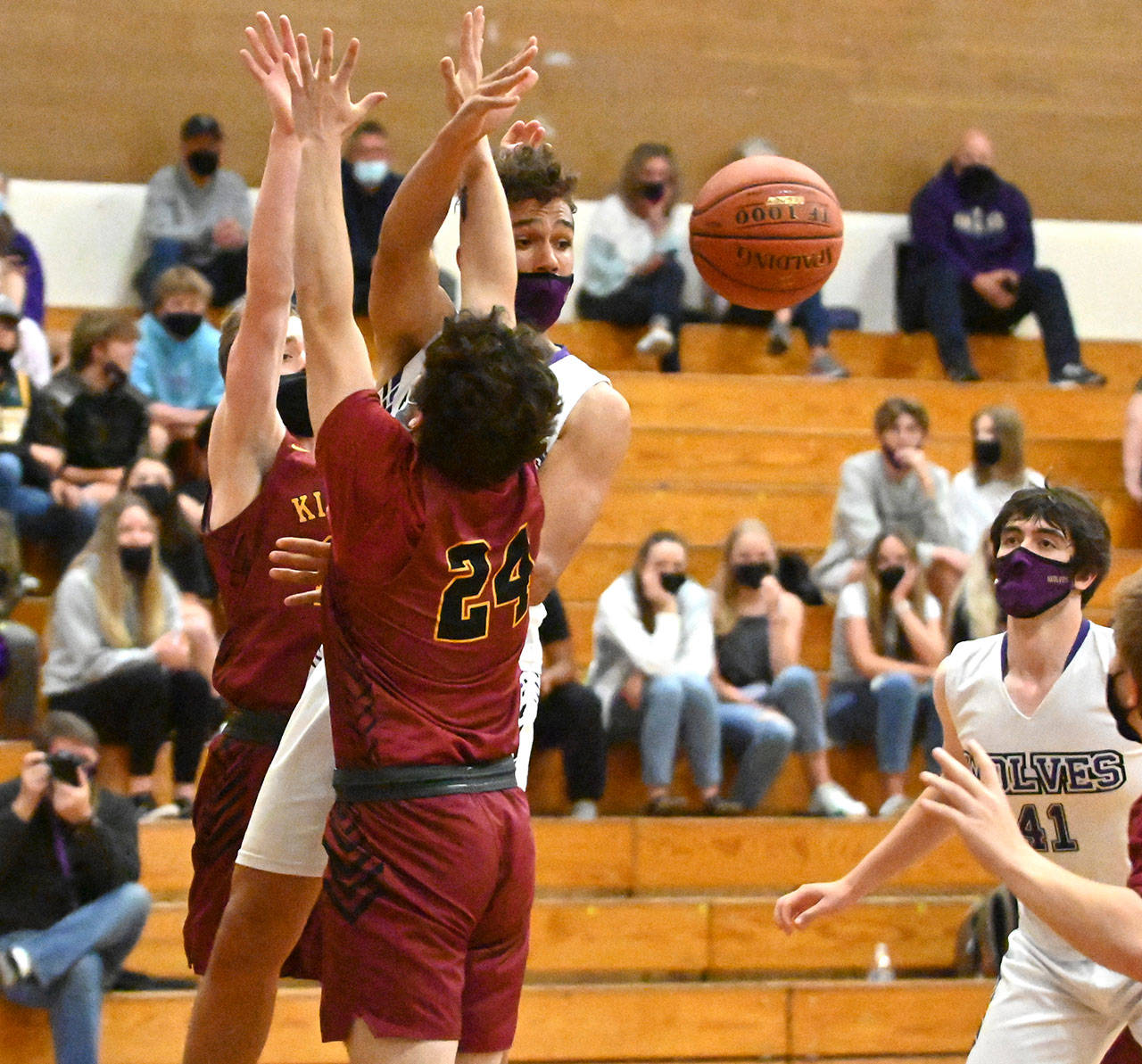 Sequim’s Hayden Eaton slips a pass through the Kingston defense in the second half of the Wolves’ 64-51 loss to the Buccaneers on May 18. Sequim Gazette photos by Michael Dashiell