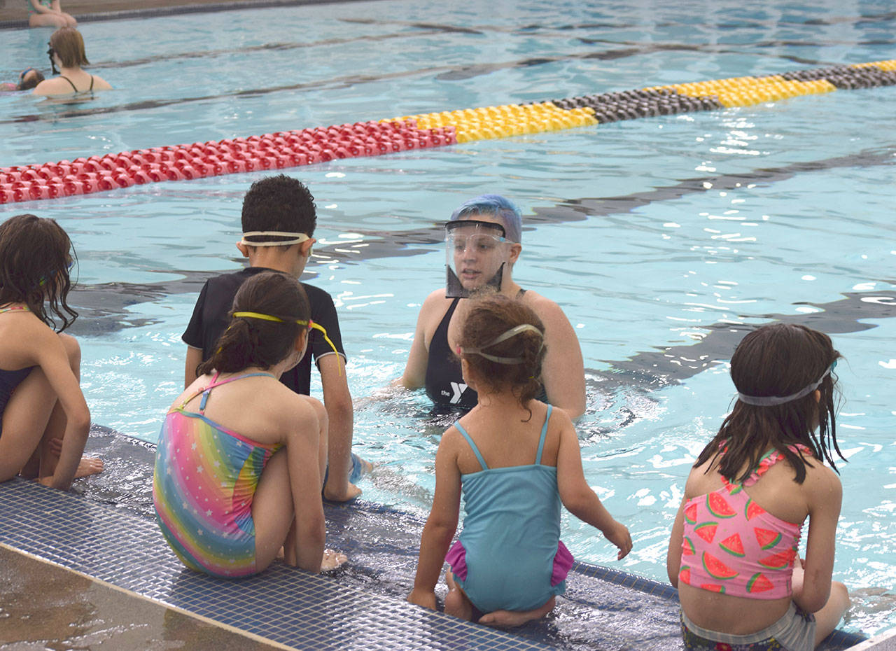 Kate Henninger, YMCA of Sequim Aquatics director, teaches youngsters at the YMCA’s Spring Break Swim Camp earlier this year. She leads a free Safety Around Water Camp for youths of ages 6-12 this June. Photo courtesy of YMCA of Sequim