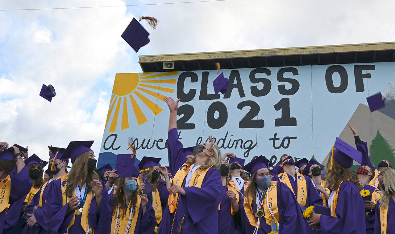 Class of 2021 Sequim High seniors toss caps into the air after completing their graduation ceremony on June 11. Sequim Gazette photo by Michael Dashiell