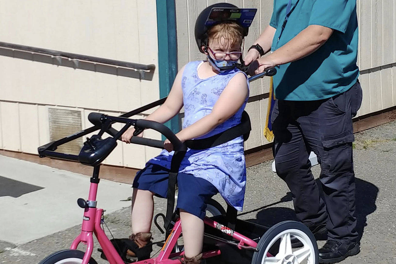 A Sequim student enjoys a ride on a newly-donated adaptive bicycle, donated by Rotary Club of Sequim. 
Rotary Club of Sequim
