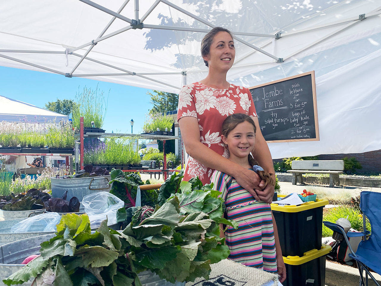 Jennifer Unruh and daughter Claire enjoy at day at the family’s Jembe Farms at the Sequim Farmers & Artisans Market on 
June 26. Photo by Emma Jane Garcia