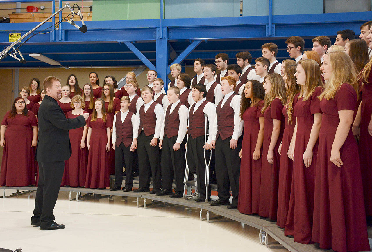 The Sequim High School Select Choir, directed by John Lorentzen, sings “The Star-Spangled Banner” in the hanger at U.S. Coast Guard Air Station/Sector Field Office on Veterans Day in 2019. Sequim Gazette photo by Michael Dashiell