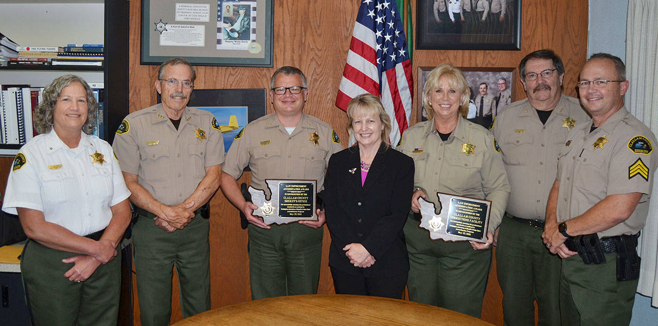 The Clallam County Sheriff’s Office’s command staff with accreditation plaques from the Washington Association of Sheriffs and Police Chiefs. Pictured, from left, are Chief Civil Deputy Alice Hoffman, Sheriff Bill Benedict, Chief Criminal Deputy Brian King, Administrative Manager Lorraine Shore, Chief Corrections Deputy Wendy Peterson, Undersheriff Ron Cameron and Corrections Sergeant Don Wenzl. Submitted photo