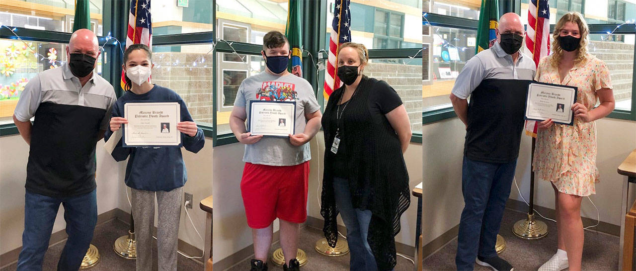 From left, Sequim Middle School students Clare Turella (with principal Mark Harris), James Dorrell (with assistant principal Candice Ward) and Skylar Krzyworz (with Harris) accept their Maxene Brandt Patriotic Youth Awards. Submitted photo