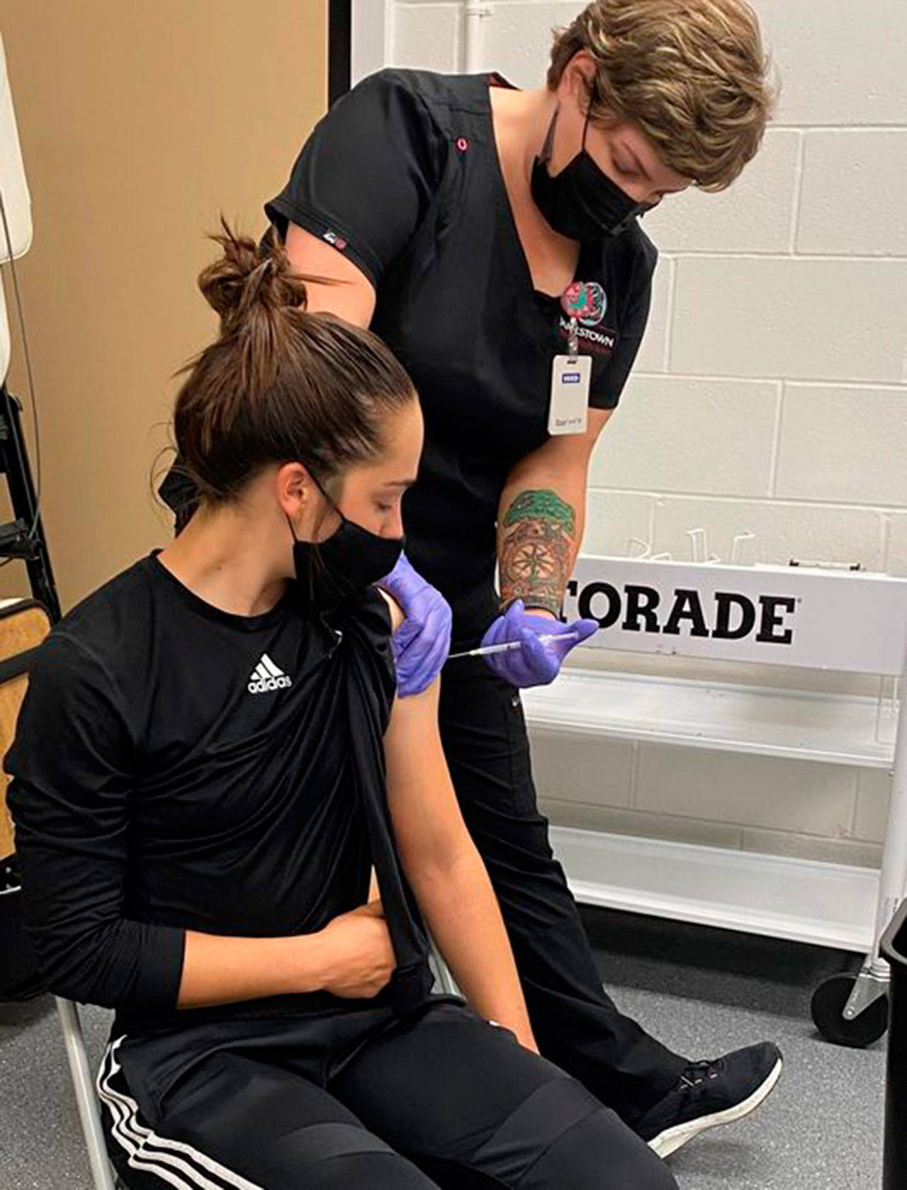 Kascia Muscutt, a soccer player and Associated Student Body president at Peninsula College, gets a COVID vaccination shot from a Jamestown Health Clinic staffer. Photo courtesy of Peninsula College