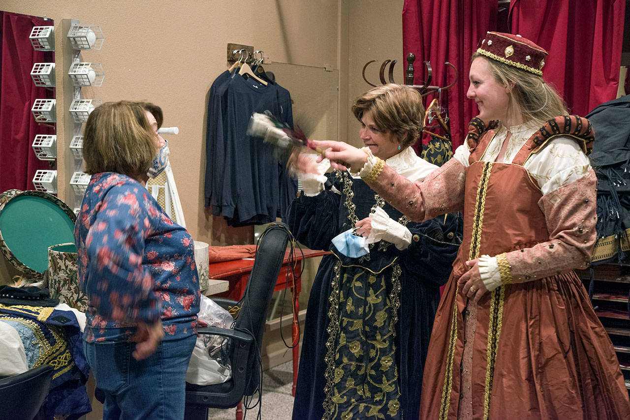 Patty McArthur is fanned by Lady Margaret Trople and Lady Merrin Parker. This is Trople’s first time in a costumed role for the theater; she started out as an assistant barkeeper. Packer says she is participating in it because likes doing theater and, “I love getting involved in my community.” Sequim Gazette photo by Emily Matthiessen