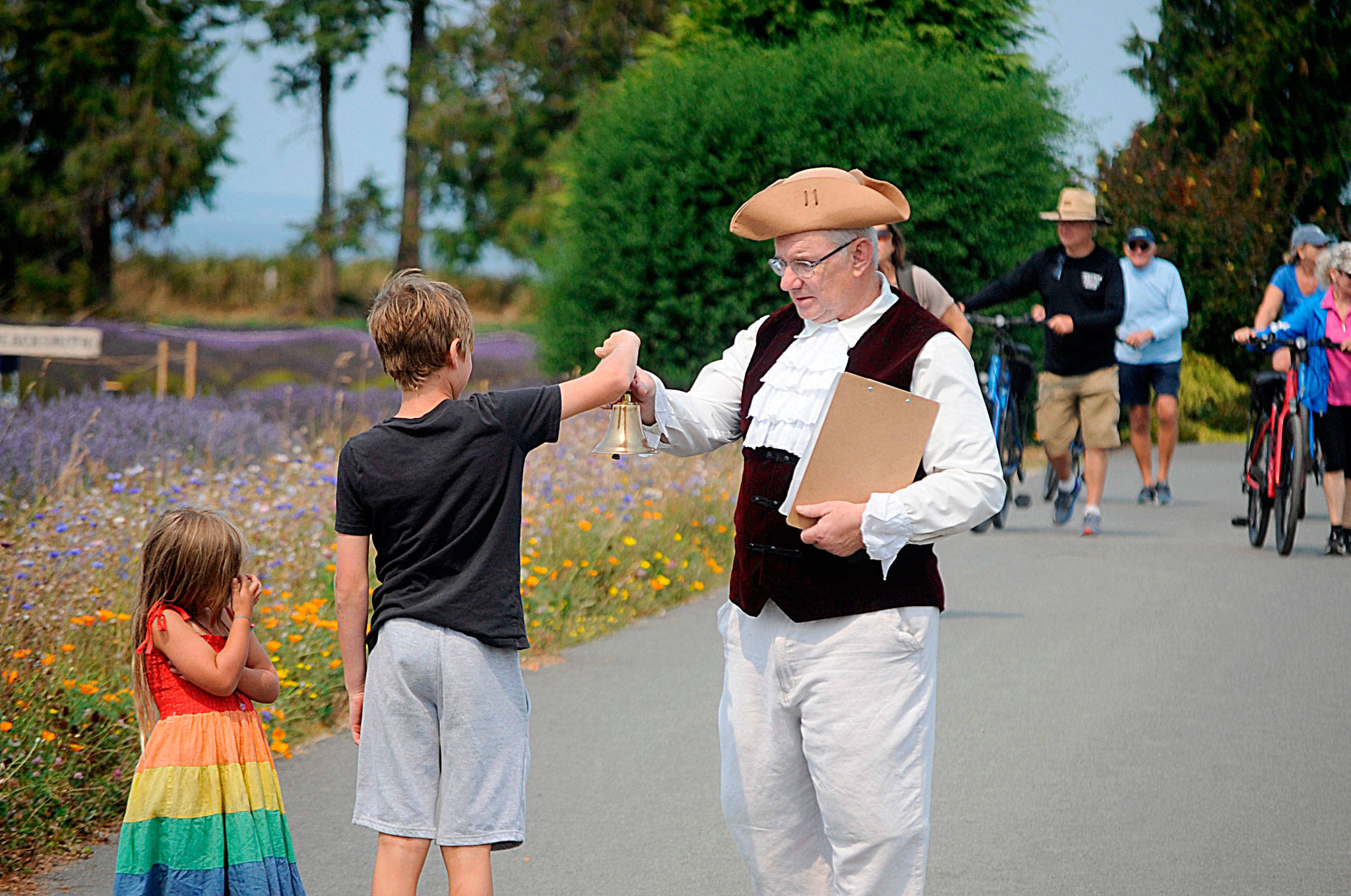 Mick Hersey of Bremerton shares his town crier duties with Lucas, 7, and Eloise Maxfield, 4, of Vashon Island prior to a skirmish at the Northwest Colonial Festival. Hersey said he’s held the role for each of the festival’s seven years.