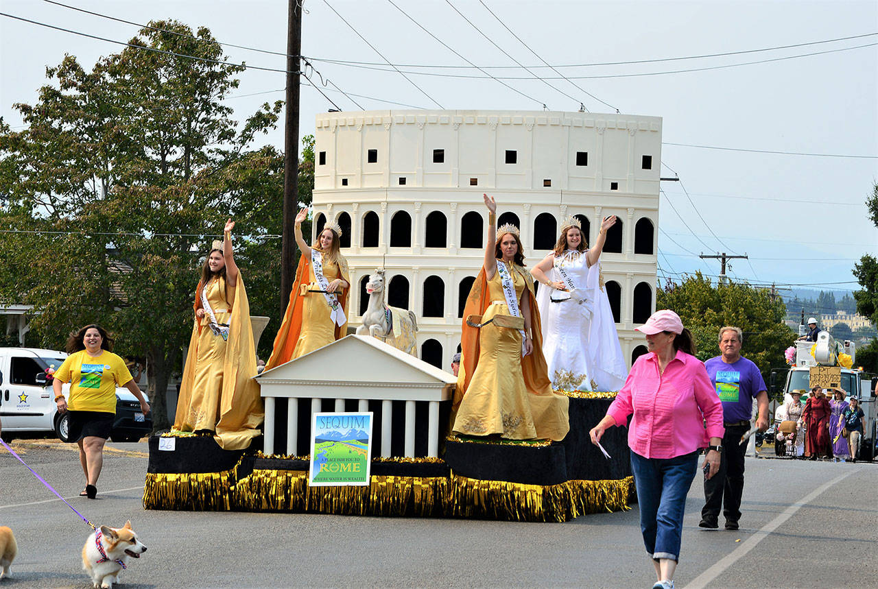The Sequim Irrigation Festival float, whose theme is “A Place for You to Rome,” rolled through Port Townsend in the 85th annual Rhododendron Festival Grand Parade on Aug. 14. The royalty, from left, are princesses Allie Gale, Zoee Kuperus and Sydney VanProyen and queen Hannah Hampton. Photo by Diane Urbani de la Paz/Olympic Peninsula News Group