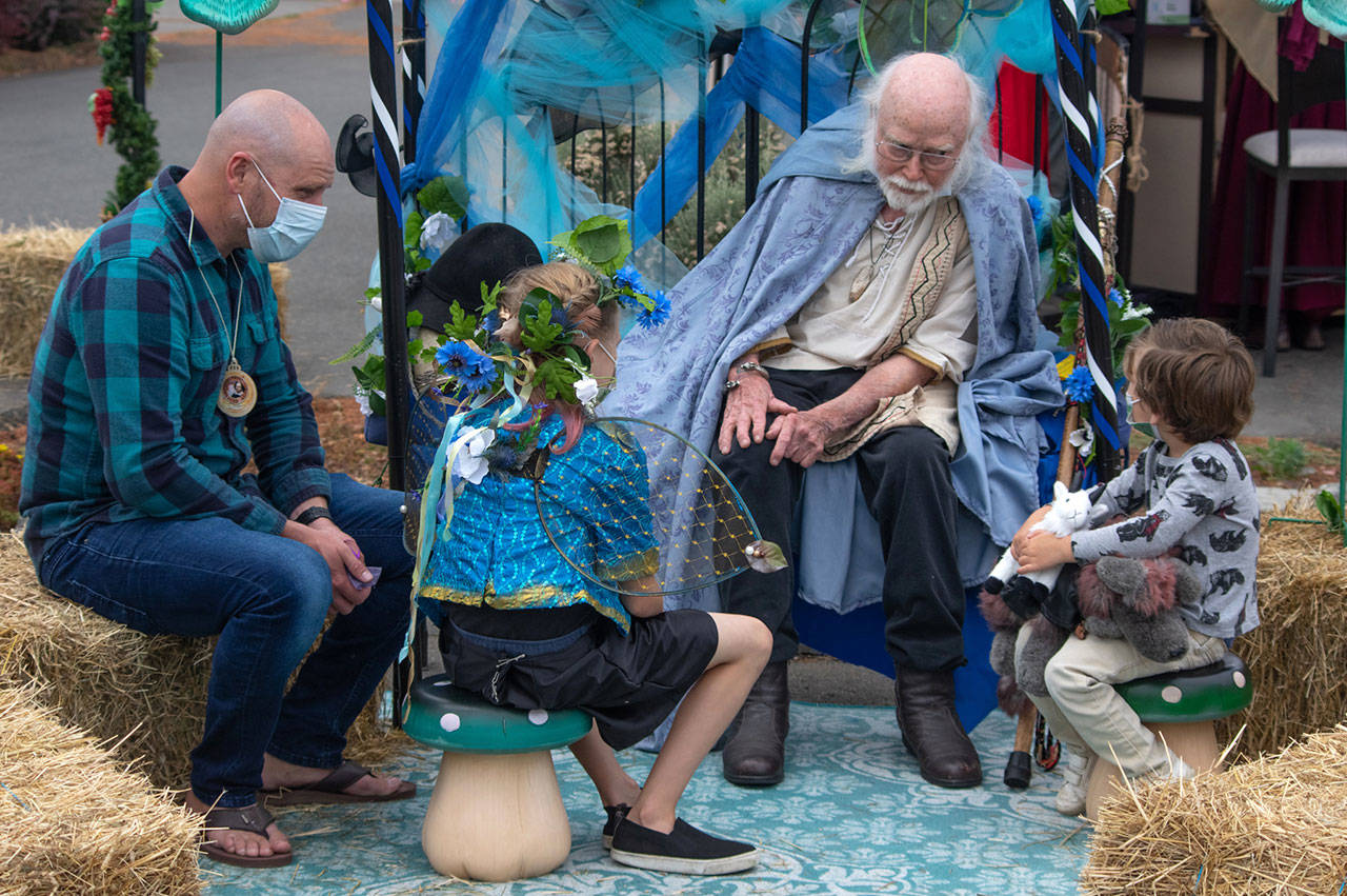 “James the Obscure” Hodgson, a storyteller since 1968, entertains a rapt audience on Aug. 22 in the parking lot of Olympic Theatre Arts in Sequim during their Renaissance Fair fundraiser. Sequim Gazette photo by Emily Matthiessen