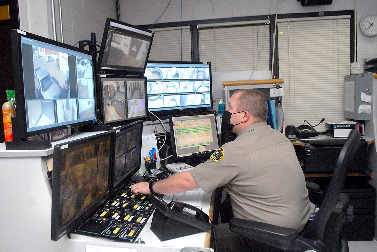 Deputy Rick Bray watches surveillance monitors from the control room at the Clallam County Jail on Aug. 25 in Port Angeles. Photo by Keith Thorpe/Olympic Peninsula News Group