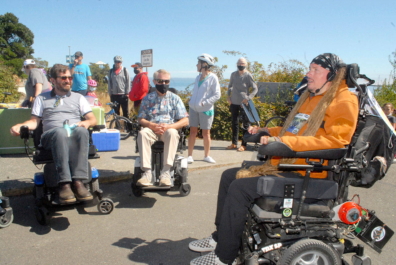 Ian Mackay, right, briefs motorized wheelchair riders, from left, Jefferson County Commissioner Greg Brotherton and Clallam County Commissioner Randy Johnson as they prepare to participate in a leg of Ian’s Ride on Aug. 28 at Port Angeles City Pier. Photo by Keith Thorpe/Olympic Peninsula News Group