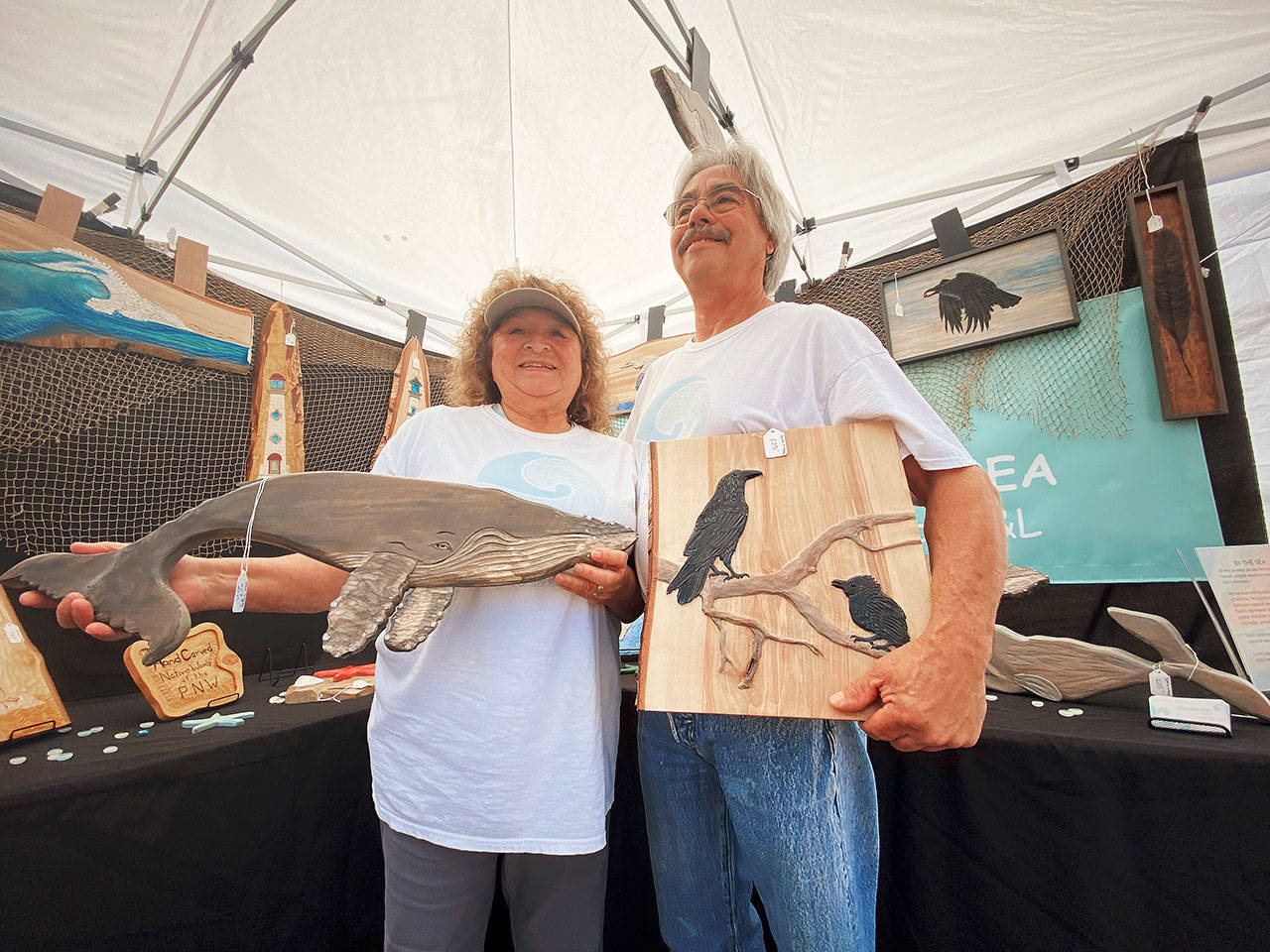 Linda and Larry Gonzalez, display some of their By the Sea Original Artwork creations at the SequiM Farmers & Artisans Market Saturday.