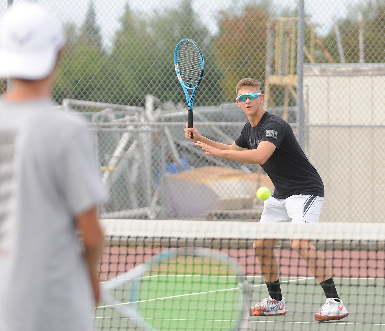 Sequim’s Connor Bear looks to hit a forehand shot in a 2021 preseason practice. He was 5-3 in singles play in 2020-21. Sequim Gazette photos by Michael Dashiell